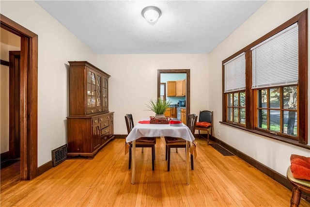 dining area with light wood-type flooring