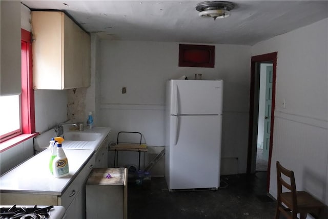 kitchen featuring sink and white fridge