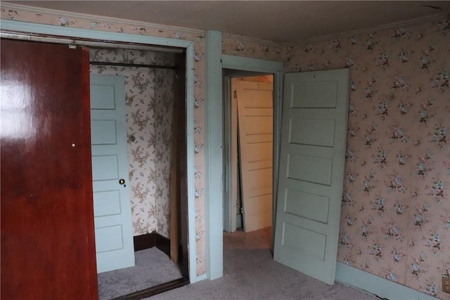 carpeted spare room featuring crown molding