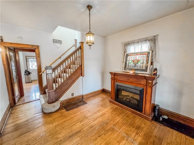 living room featuring light hardwood / wood-style floors and an inviting chandelier