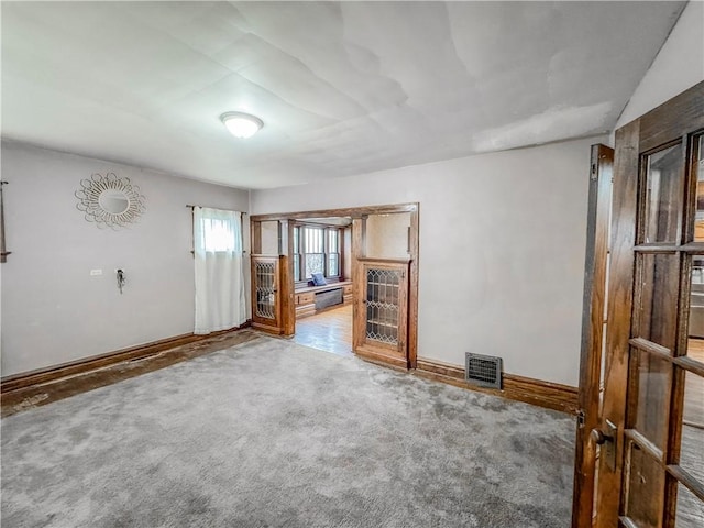 unfurnished living room with carpet flooring and vaulted ceiling