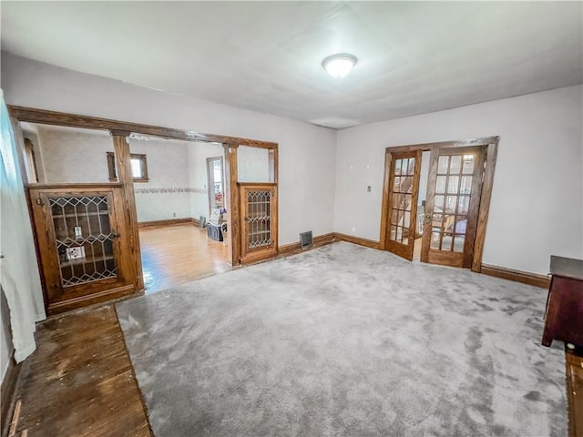 spare room featuring hardwood / wood-style floors and french doors