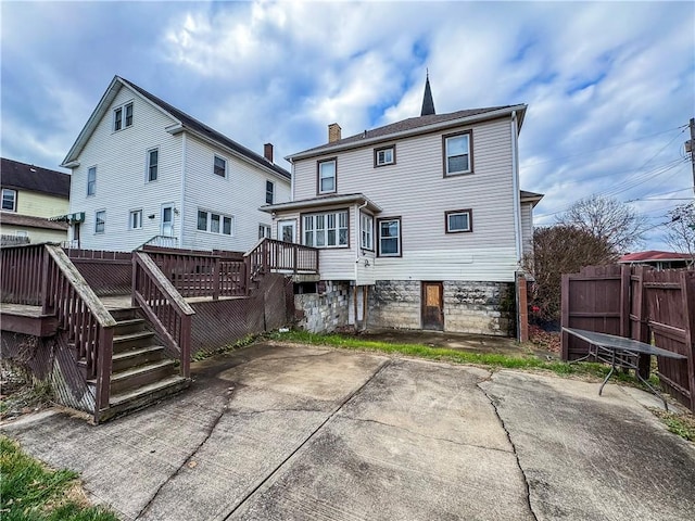 rear view of house with a patio area and a wooden deck