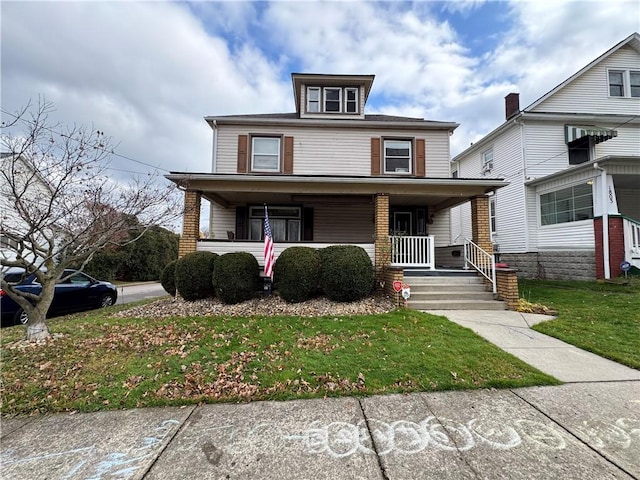 front of property with a porch and a front lawn