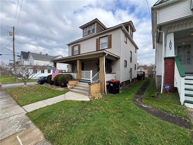 view of front of home with a porch and a front lawn