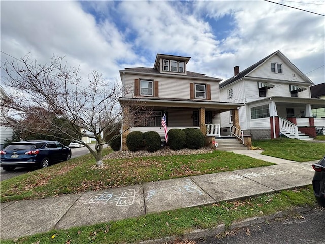 view of front of house with a front lawn and covered porch