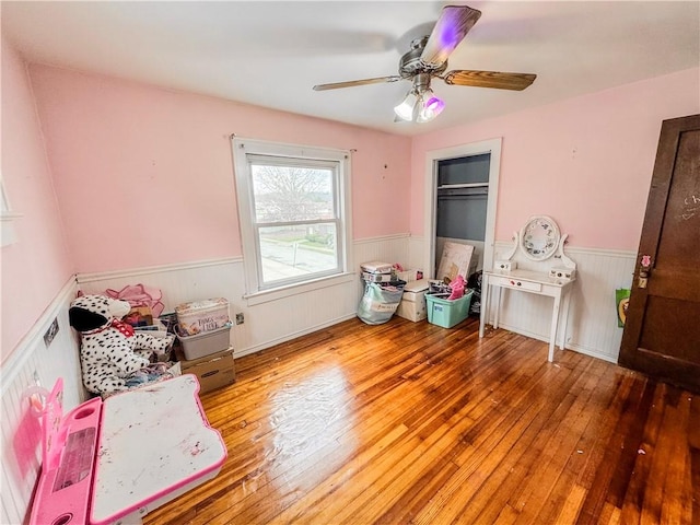 bedroom with a closet, ceiling fan, and hardwood / wood-style floors