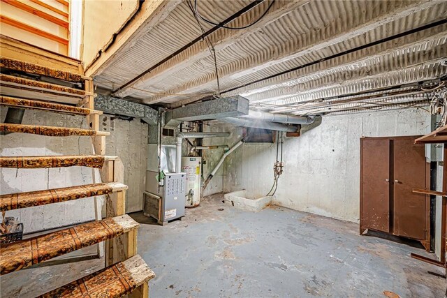 basement featuring heating unit and water heater