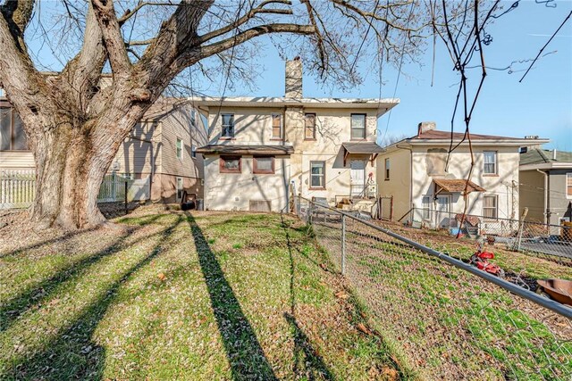 rear view of house with a yard