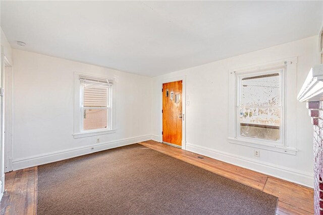 empty room with hardwood / wood-style floors