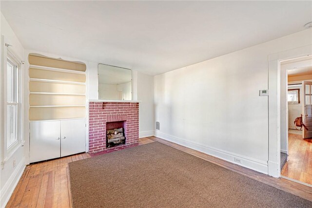 unfurnished living room featuring a fireplace and hardwood / wood-style floors