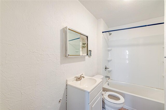 full bathroom featuring a textured ceiling, vanity, toilet, and shower / bathtub combination