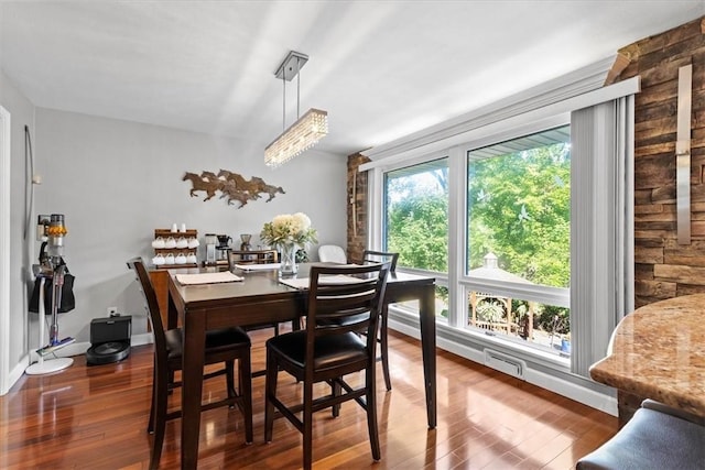 dining area featuring hardwood / wood-style floors and a chandelier