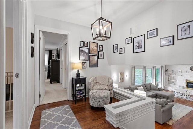 living room with a notable chandelier and dark hardwood / wood-style floors