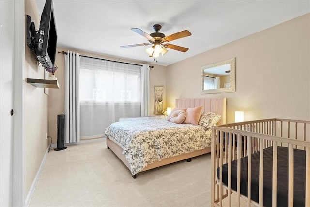 bedroom featuring ceiling fan and light colored carpet