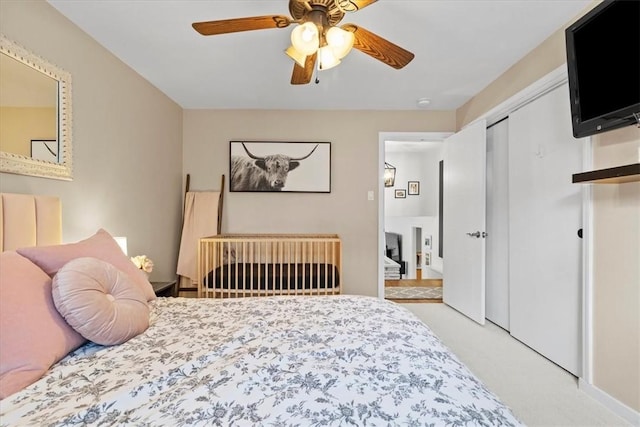 carpeted bedroom with ceiling fan and a closet