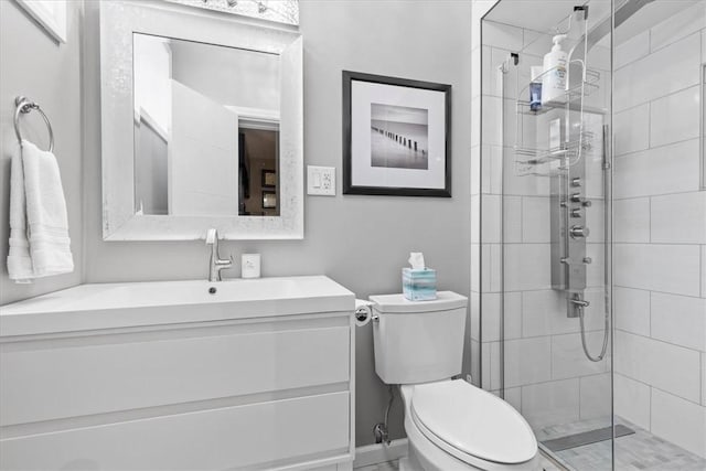 bathroom featuring walk in shower, vanity, and toilet