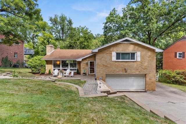 view of front of house with a garage, a front lawn, and a patio area