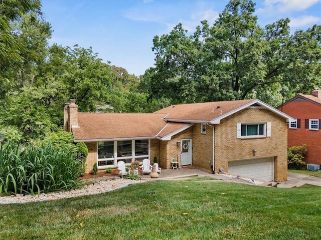 view of front of house with a garage and a front lawn