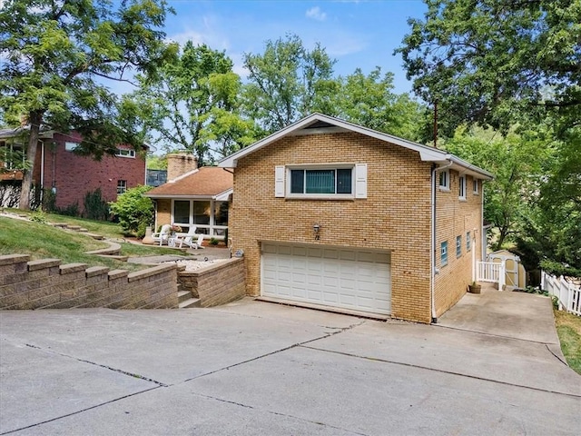 view of front of home with a shed and a garage