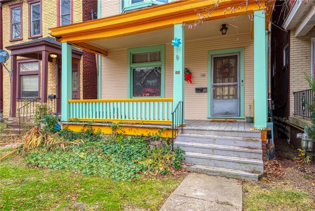 view of exterior entry with a porch