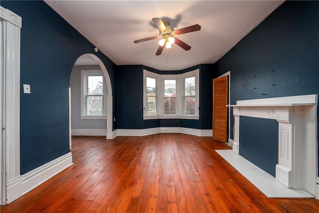 unfurnished living room featuring ceiling fan and hardwood / wood-style floors