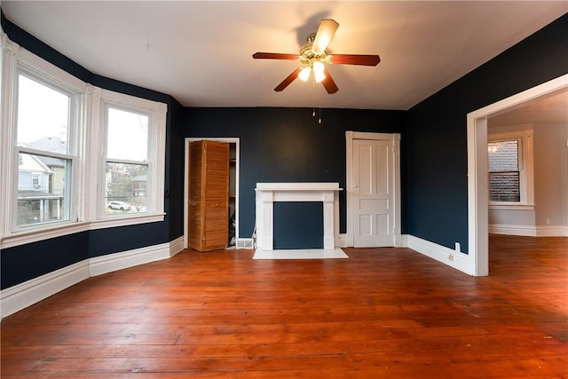 unfurnished living room with hardwood / wood-style flooring and ceiling fan