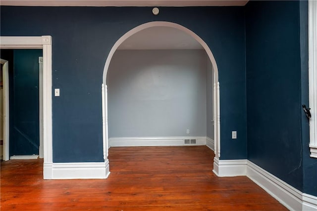 unfurnished room with hardwood / wood-style flooring