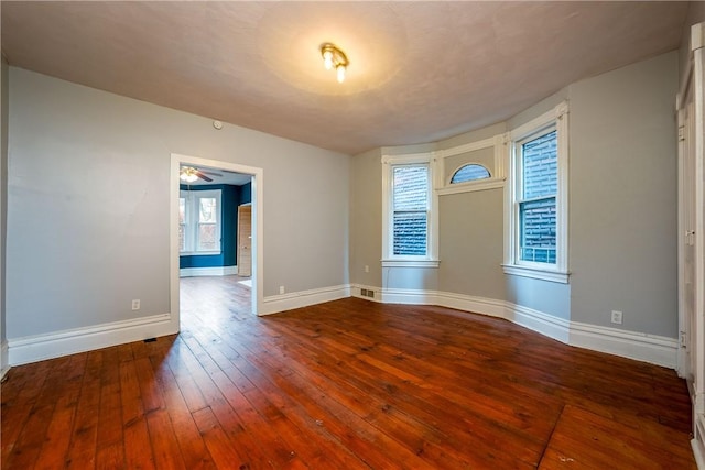 empty room with hardwood / wood-style floors and ceiling fan