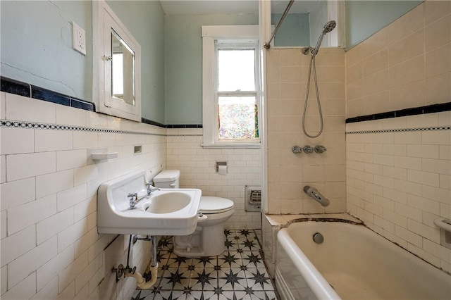 full bathroom featuring sink, toilet, tile walls, and tiled shower / bath