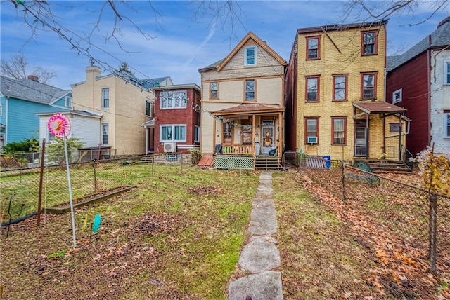 view of front of property with a porch and a front yard