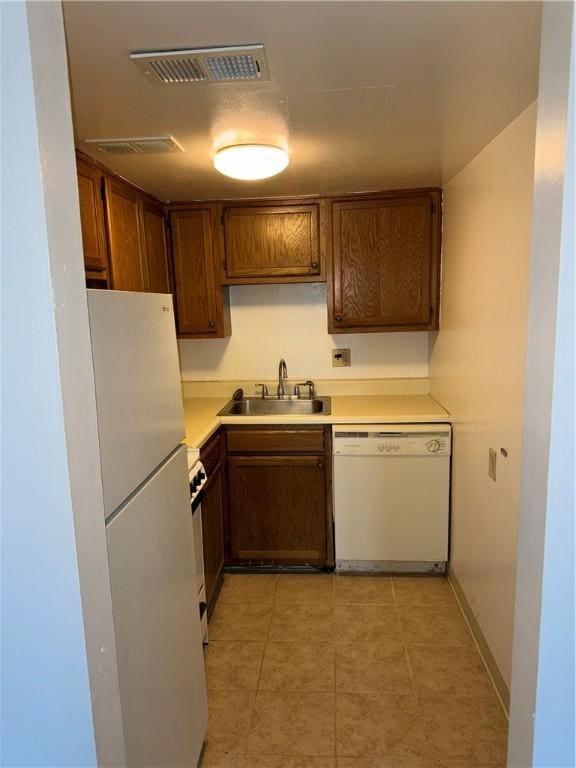 kitchen featuring sink and white appliances