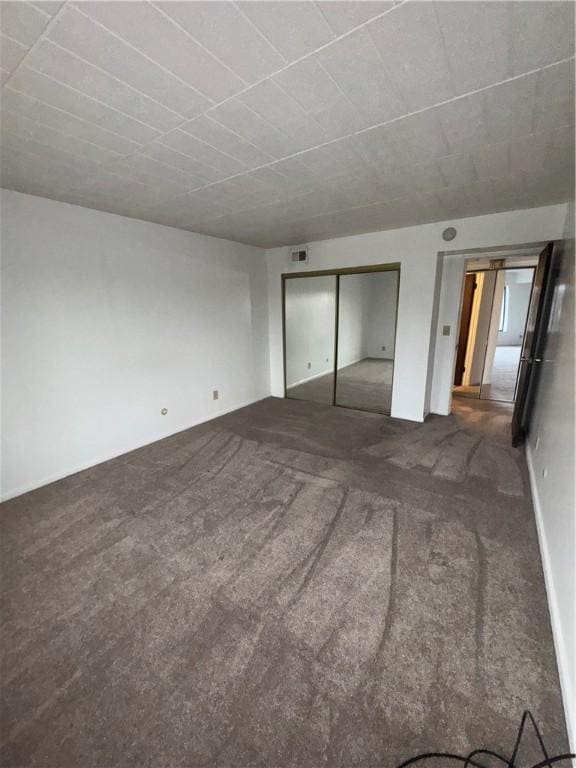 unfurnished bedroom with carpet and a closet