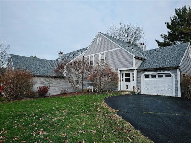 view of side of property with a yard and a garage