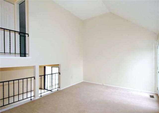 bonus room with carpet flooring and high vaulted ceiling