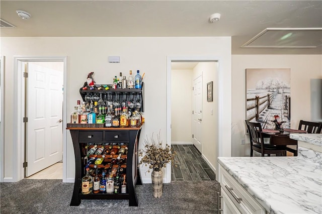 bar with carpet and white cabinetry