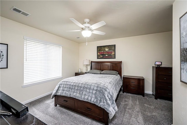 bedroom with ceiling fan and dark carpet