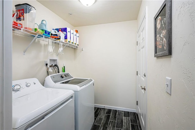 laundry room with independent washer and dryer and dark wood-type flooring