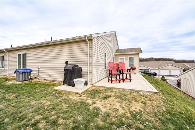 back of property with a lawn and a patio area