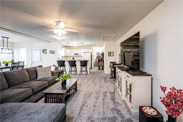 living room with ceiling fan and light carpet