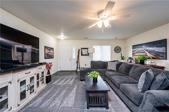 carpeted living room featuring ceiling fan