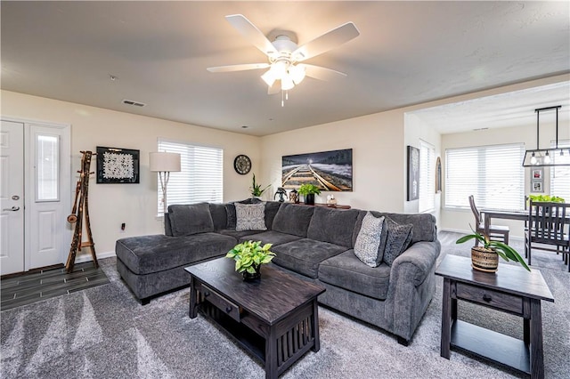 living room featuring a wealth of natural light, ceiling fan, and hardwood / wood-style flooring