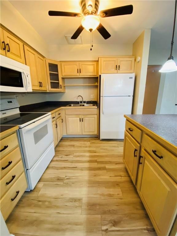 kitchen featuring pendant lighting, light brown cabinets, white appliances, sink, and light hardwood / wood-style flooring