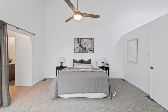 bedroom featuring carpet flooring, ensuite bathroom, and ceiling fan