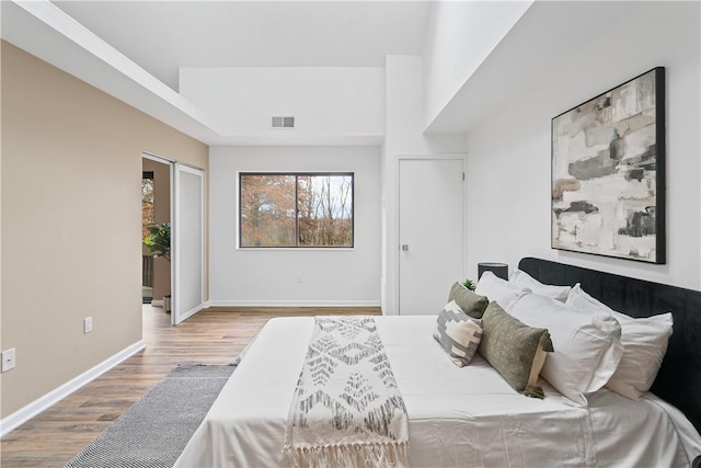 bedroom featuring wood-type flooring and a closet