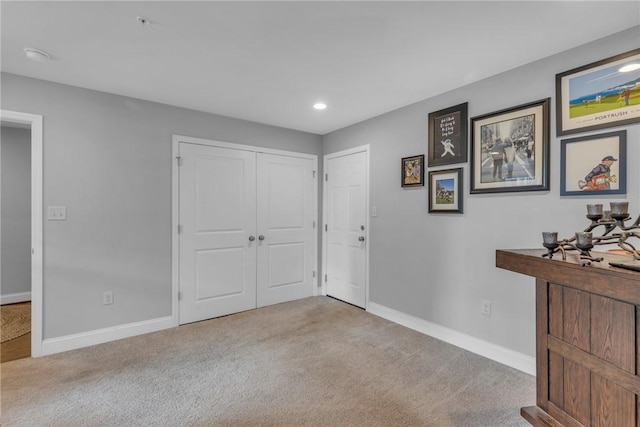 foyer entrance with light colored carpet