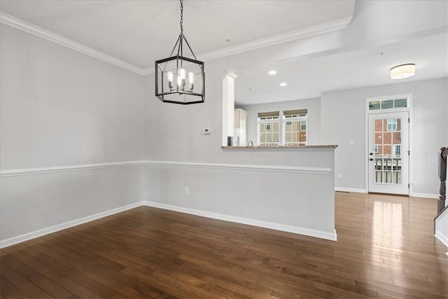 interior space featuring crown molding, dark hardwood / wood-style flooring, and a chandelier