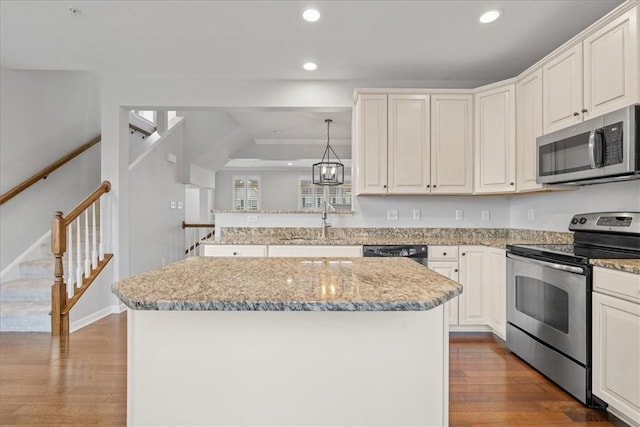 kitchen featuring sink, a kitchen island, dark hardwood / wood-style floors, and appliances with stainless steel finishes