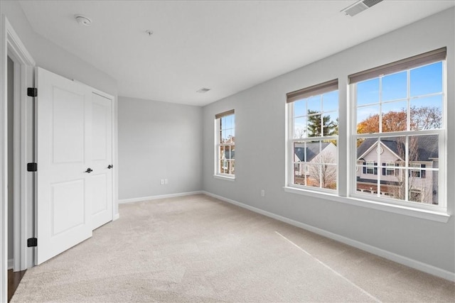 unfurnished bedroom with light colored carpet