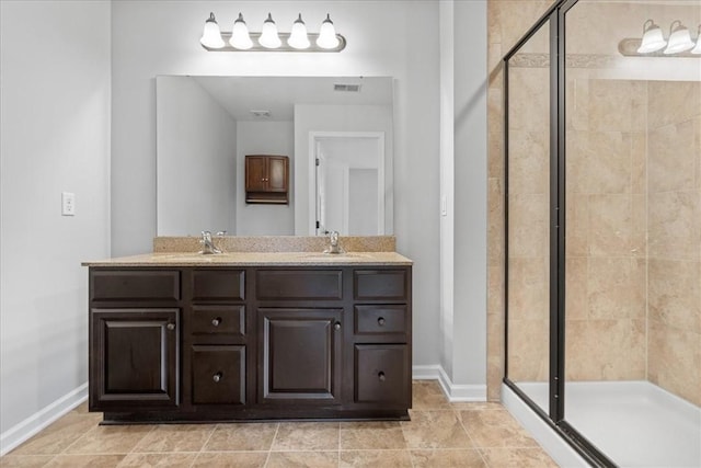 bathroom featuring tile patterned flooring, vanity, and walk in shower